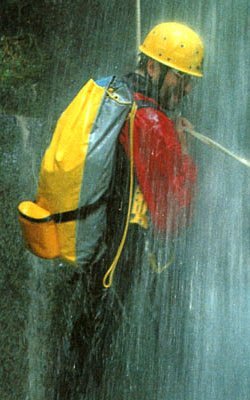 canyoning abseiling under a waterfall