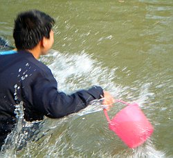 Jumping into the water wearing hoodie.