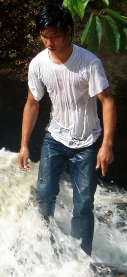 with jeans and t-shirt in a waterfall